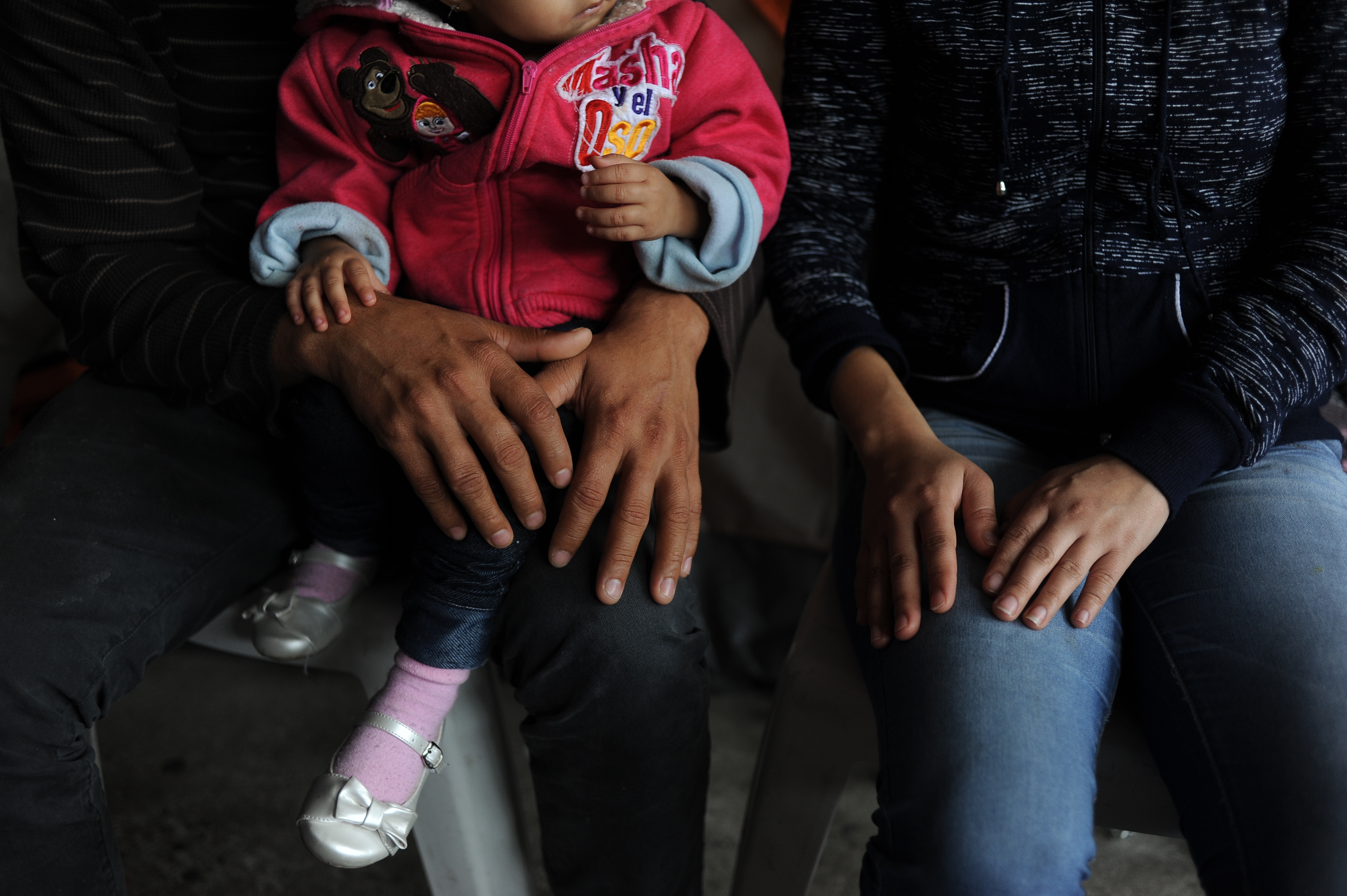 A family seeking asylum waits to hear their fate. 